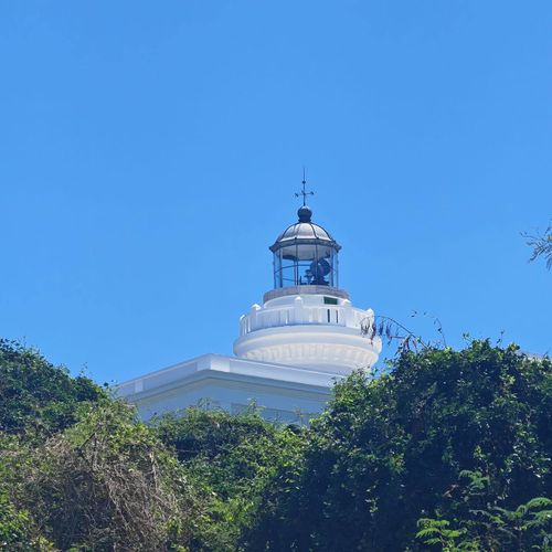 Discover a local landmark! This beautiful lighthouse stands tall against a clear blue sky, a guiding light and a picturesque sight on the Malolos coast.