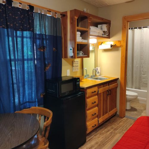 Main room:  includes a full-size bed, table, and small sink / kitchenette.