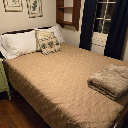 Bedroom #2:  features a full-size bed, nightstand, lamp, and dresser.