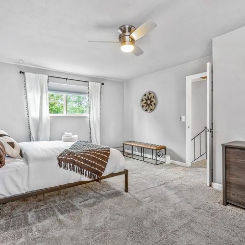 The master suite on this level is spacious and includes a king-size bed, a dresser, nightstands, and more!