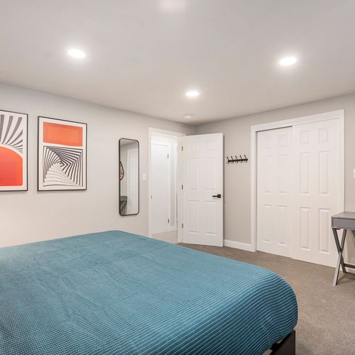 The spacious downstairs third bedroom features a functional desk, making it a perfect blend of style and convenience for work or relaxation.