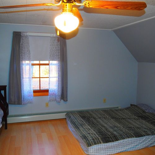 Bedroom #3 (second floor):  includes a queen-size bed, a full-size bed, and a twin-on-full bunk bed. Also has a dresser. Closet, and ceiling fan.