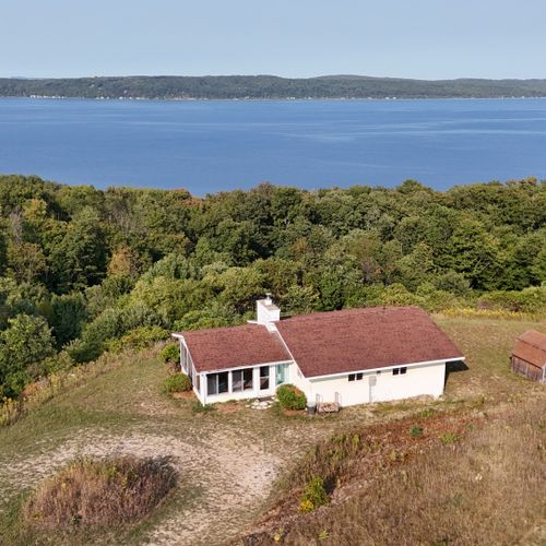 Overview:  aerial photo of the cottage with crystal lake in the background.
