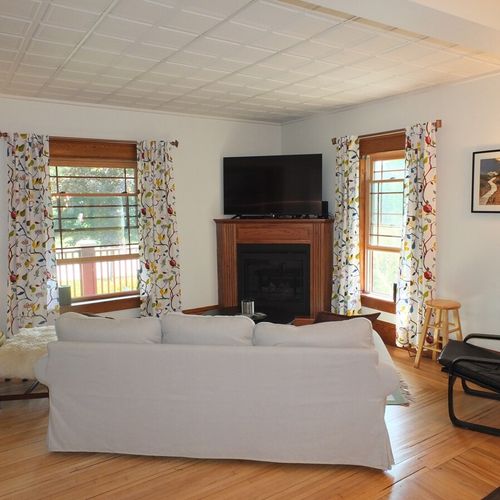 Living room:  the living room features a nice new sofa, a coffee table, a couple chairs, a large flat screen television, gas fireplace, and lots of natural light from the windows!