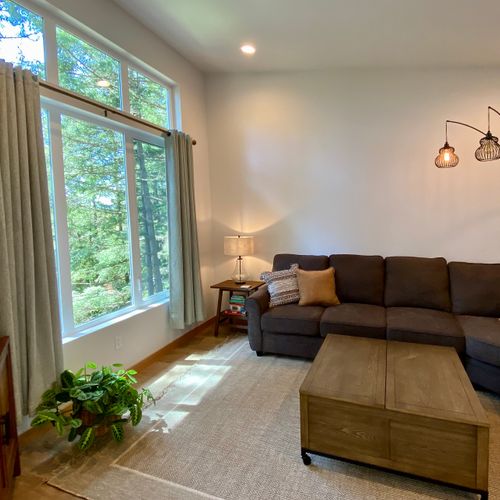 Two rooms, one seamless flow — the cozy TV lounge opens straight into the bright main living area.