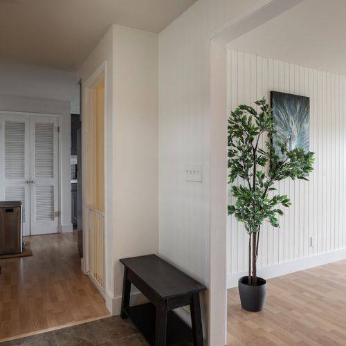 Open entryway leading to the living room, kitchen, or downstairs.