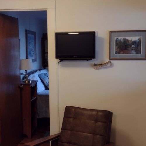 Living room:  the cabin has cute living room with a loveseat, dining table, comfy chair, and streaming television.
