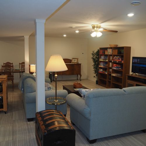Living room:  the apartment has a very comfortable living room with a sleeper sofa, comfy chair, ceiling fan, table, and television.