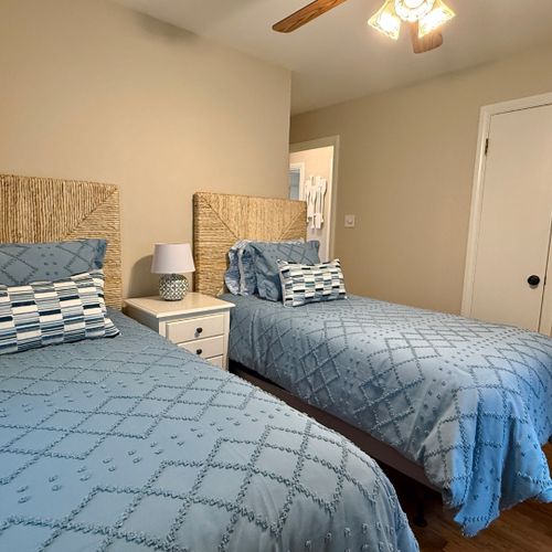 Bedroom #3:  features 2 matching twin beds, ceiling fan, closet, nightstand, and lamp