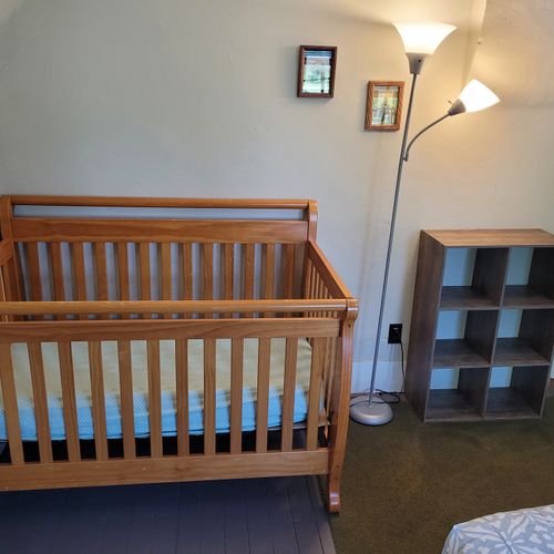 BEDROOM #1 (SECOND FLOOR):  Features a queen-size bed, baby crib, and closet.