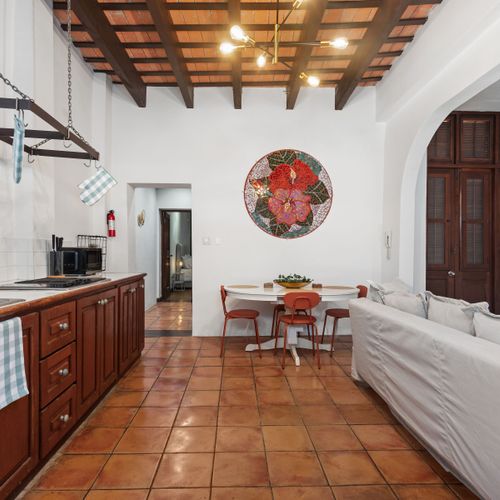 Unwind in comfort on the cozy couch, perfectly set in this welcoming dining area.