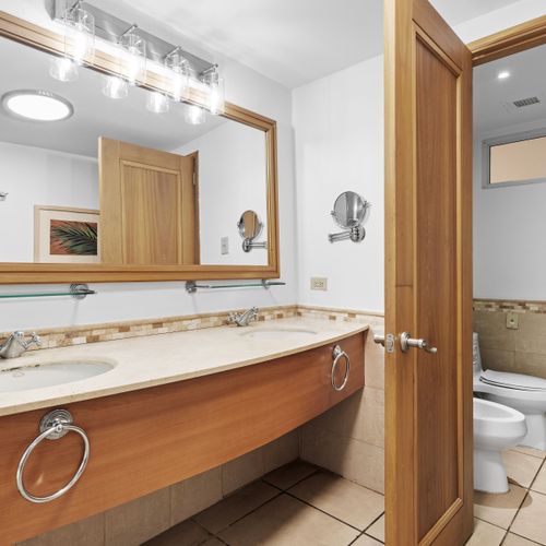 Expansive bathroom vanity with dual sinks, perfect for getting ready with ease and comfort.