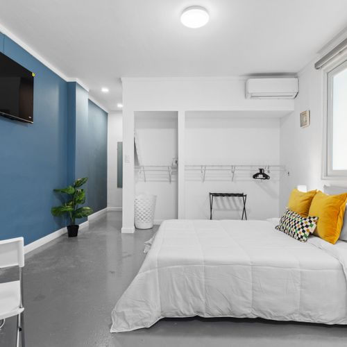 Serene Slumber: Sink into the plush comfort of this queen-sized bed, set against a calming backdrop, promising restful nights and peaceful mornings.