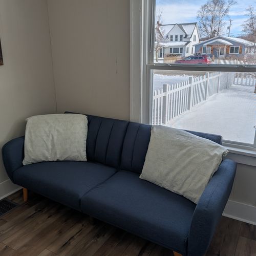 LIVING ROOM:  Very comfy and cozy living room with 2 sofas, a futon, a rocking chair, coffee table, new flooring, and new live streaming television.