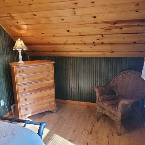 Bedroom #2 (upper level):  features a queen-size bed, chair, dresser, closet, ceiling fan, nightstands, and lamp