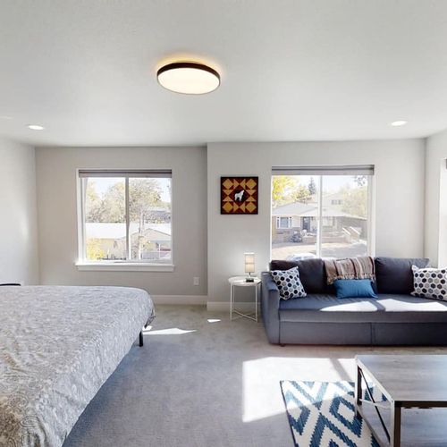 Relax in comfort and enjoy an abundance of light in this master bedroom, featuring a king-size bed, sitting area, and private ensuite bath.