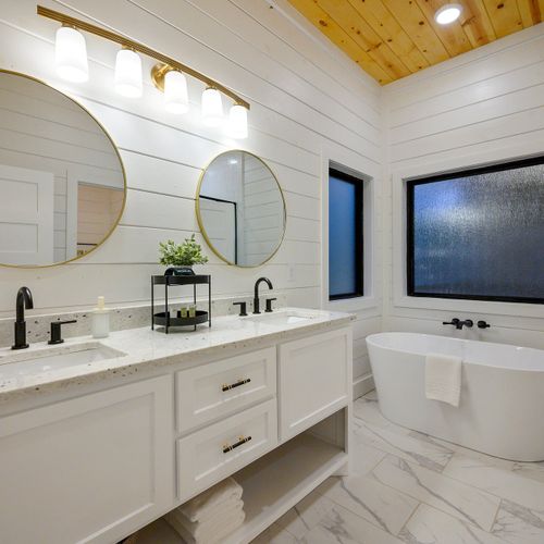 This private bathroom has a double vanity and a soaking tub.