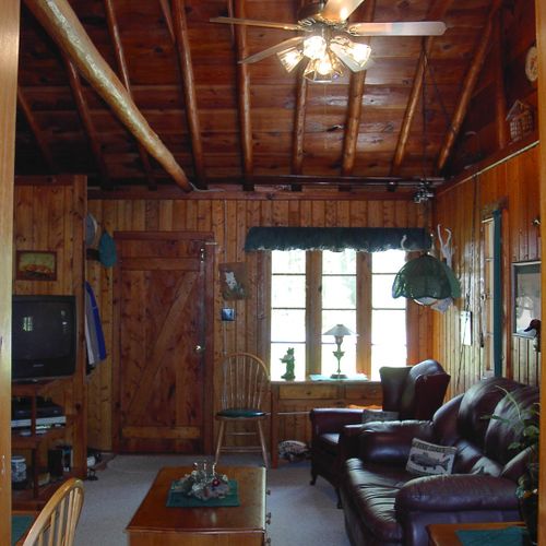 Living room:  the cabin has a very comfy and cozy living room with a sofa, comfy chair, gas fireplace, coffee table, and live streaming television with roku