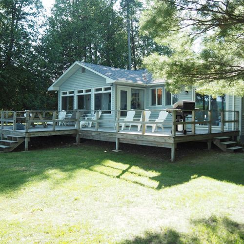 Overall:  the back of the house, highlighting the large backyard deck and the large backyard.
