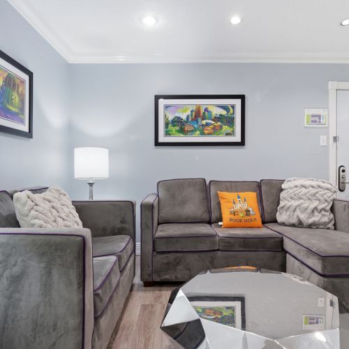 Gather around in this warm living room w/ plush sofas & welcoming energy.
