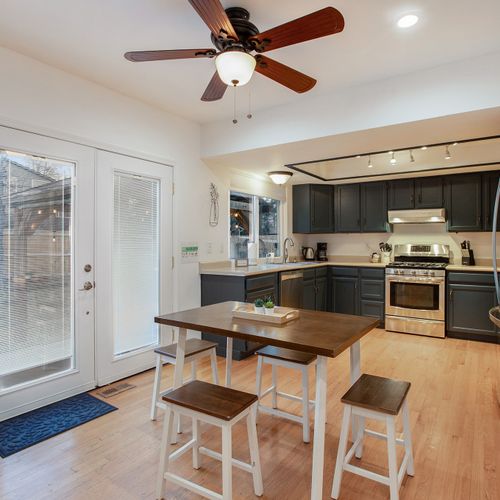 The open concept kitchen features a small bistro table for 4. The double doors open to the large backyard for extra entertaining space.