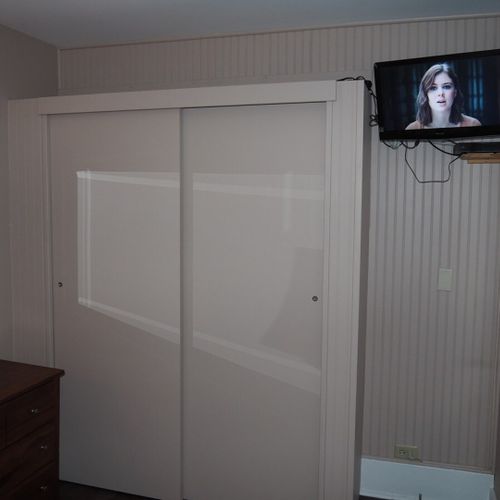 Bedroom #1:  features a queen-size bed, nightstand, lamp, dresser, mirror, closet, and television.