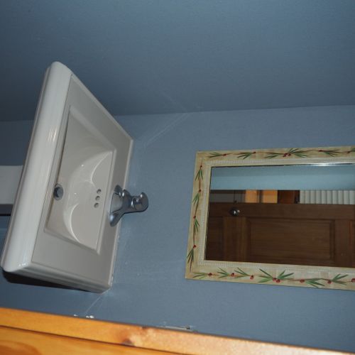Bathroom #2 (main floor):  half bathroom on the main floor with a sink, shower, and a washer and dryer.