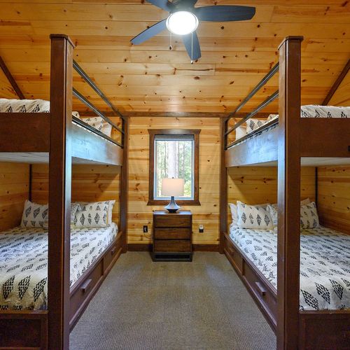 Off the loft is the bunk room featuring 4 Queen beds!