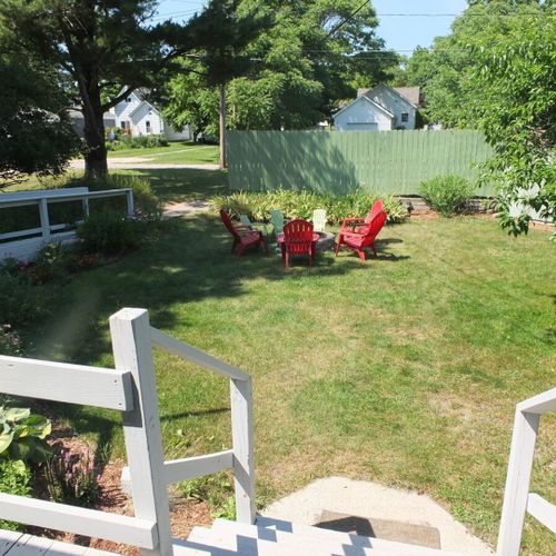 Exterior:  looking at the backyard from the deck. Note that the parking area is behind the green fence.