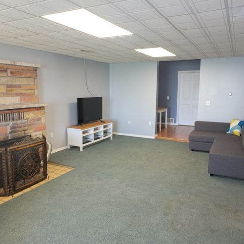 Living room:  the living room is large and features a television (with cable television), wood fireplace, a sofa bed, and a futon.