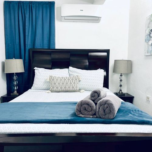 Eco Friendly | Solar Powered Stay 33 Indulge in ultimate comfort in our serene main bedroom, featuring a luxurious queen-size bed and a Smart TV for your entertainment. Perfect for unwinding after a day of adventures.