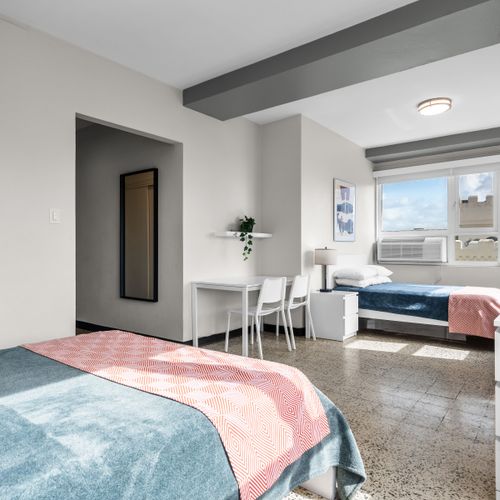 Step into a clean and comfortable space designed for your relaxation. This bright bedroom offers a tranquil setting for a perfect night's sleep.