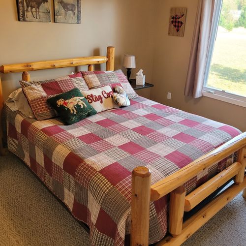 BEDROOM #1 (FIRST FLOOR):  Features a beautiful queen-size bed, ceiling fan, dresser, nightstand, lamp, closet, and makeup table with chair and mirror.