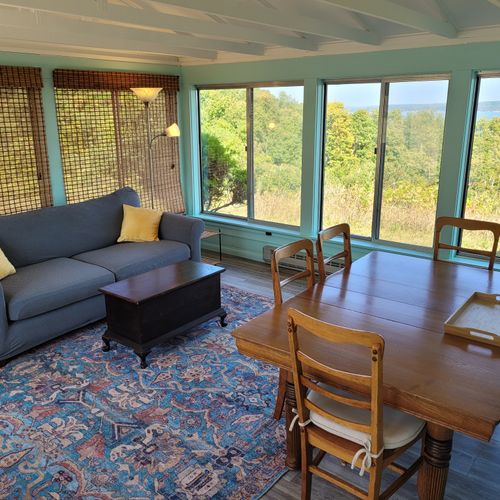 Overview:  the home also has a lovely sunroom with a dining / game table, sofa, chairs, and another great view of crystal lake!