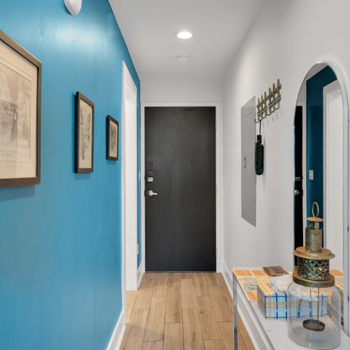 Clean, welcoming entryway w/ a charcoal door & teal walls to set the tone.