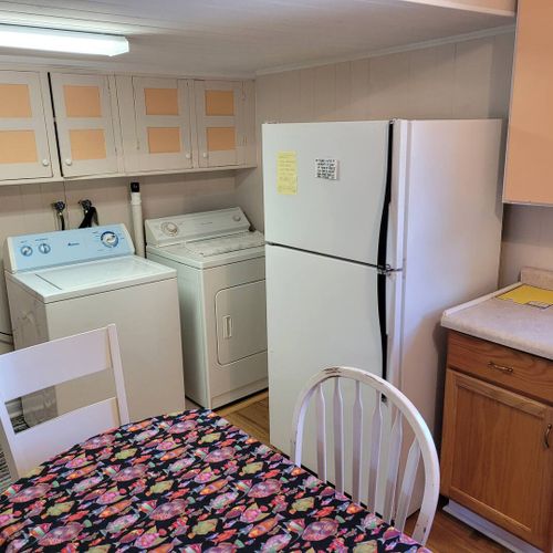 KITCHEN AND DINING AREA:  Full kitchen with a good supply of cooking and dining utensils.  Also includes dining area and washer and dryer.