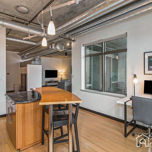 - enjoy casual dining at the kitchen island or log in from the bright workstation nearby
- industrial ceilings and pendant lights bring energy to this open concept layout
- perfect mix of functionality and urban style for work and play
