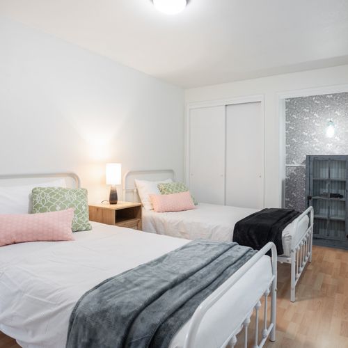 Upstairs guest bedroom with shared full bathroom.