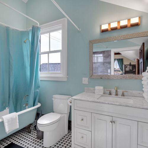Full bathroom w/ double vanity & soothing blue tones.