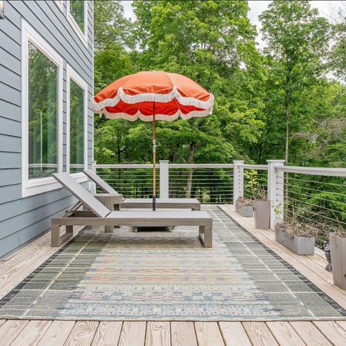 The spacious back deck is the place to be on a warm summer day