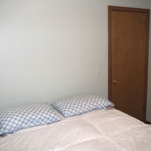 Bedroom #1 (main floor):  features a queen-size bed and a dresser.