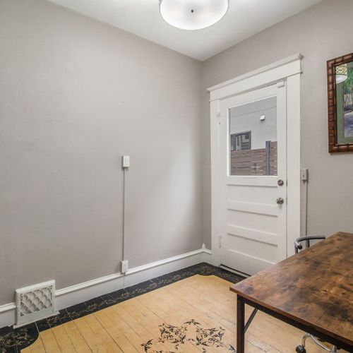 Work from the second desk, with original hardwood floors.