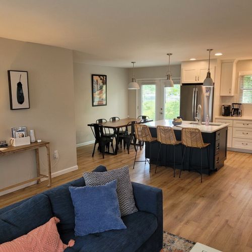Living room:  the living room features a cozy sectional that unfolds into a double bed. There is also a coffee table, hutch, ceiling fan, a couple portable chairs, a dog bed, and a large smart tv.