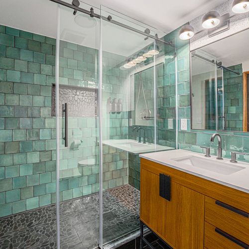 The focal point of this basement bathroom is a spacious walk-in shower, complemented by a stylish vanity that adds functionality and elegance to the space.