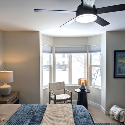 BEDROOM #1 (PRIMARY BEDROOM, MAIN FLOOR):  This is large and beautiful bed featuring a king-size bed, private ensuite full bathroom, private television, dresser, chair, ceiling fan, and closet.