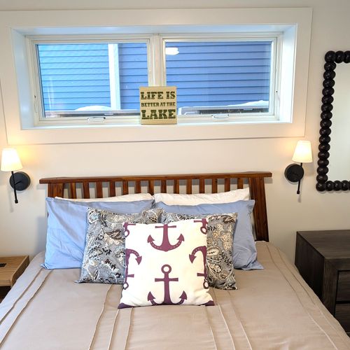 BEDROOM #4 (LOWER LEVEL):  Features a queen-size bed, ceiling fan, dresser, mirror, nightstand, nightlamps, private television, and a great view of Crystal Lake!