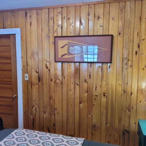 Bedroom #1:  features a queen-size bed, nightstands, lamps, a dresser, and a mirror.