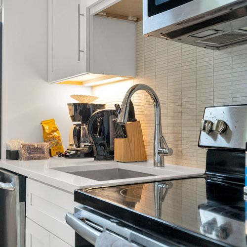 Stainless steel appliances, coffee essentials & cooking tools all within easy reach.
