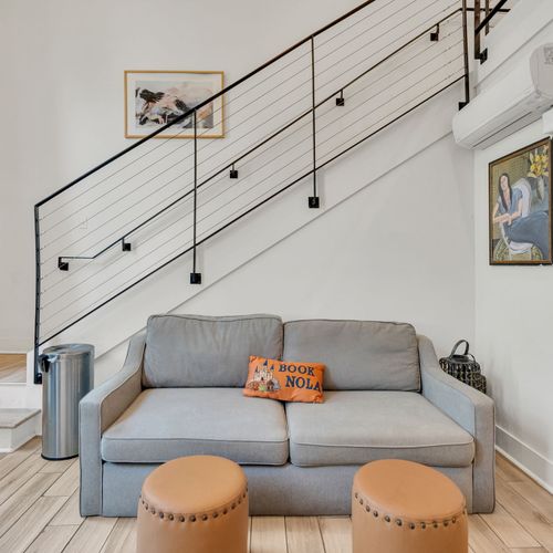 Relax in this stylish living area with modern decor, a comfy loveseat, and chic accents—perfect for unwinding after a day in the city.
