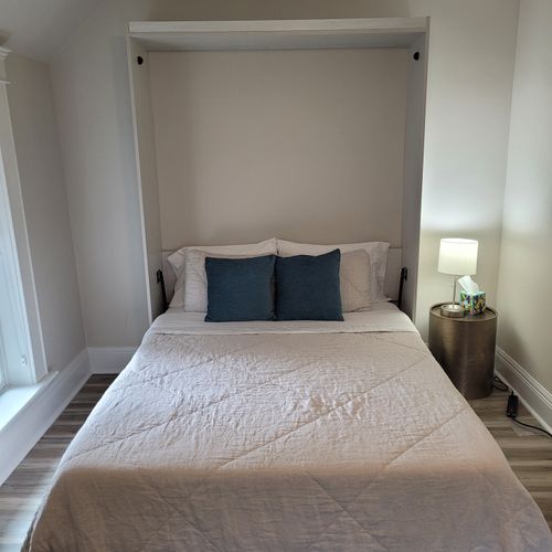 Bedroom #3 (second floor):  features a queen-size murphy bed, window a/c unit, ceiling fan, desk with chair, comfy chair, and a closet.